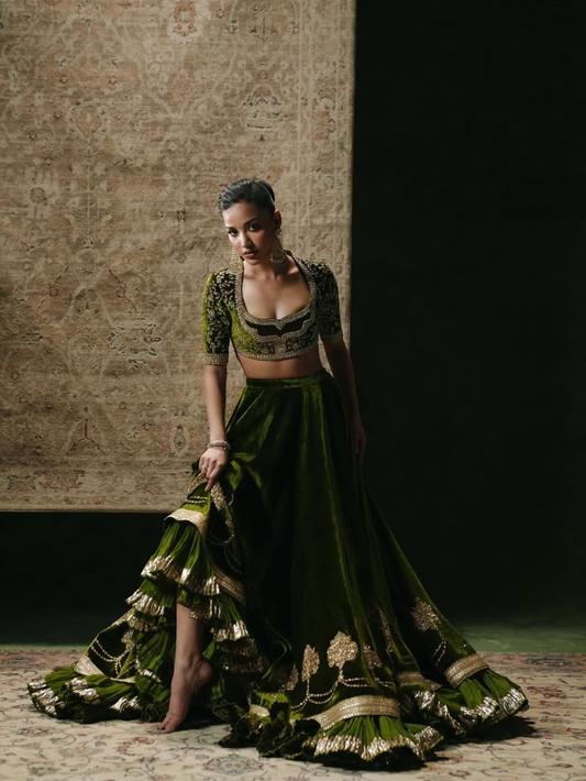 Olive Noor Velvet by MAIRAZ — full-length pose showing the flared lehenga and embroidered hem; design reference