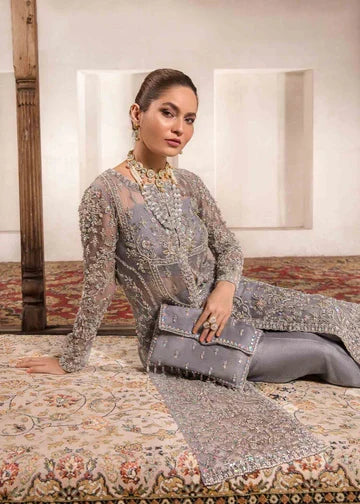 Chandi silver grey formal outfit seated view showing embroidered neckline and clutch