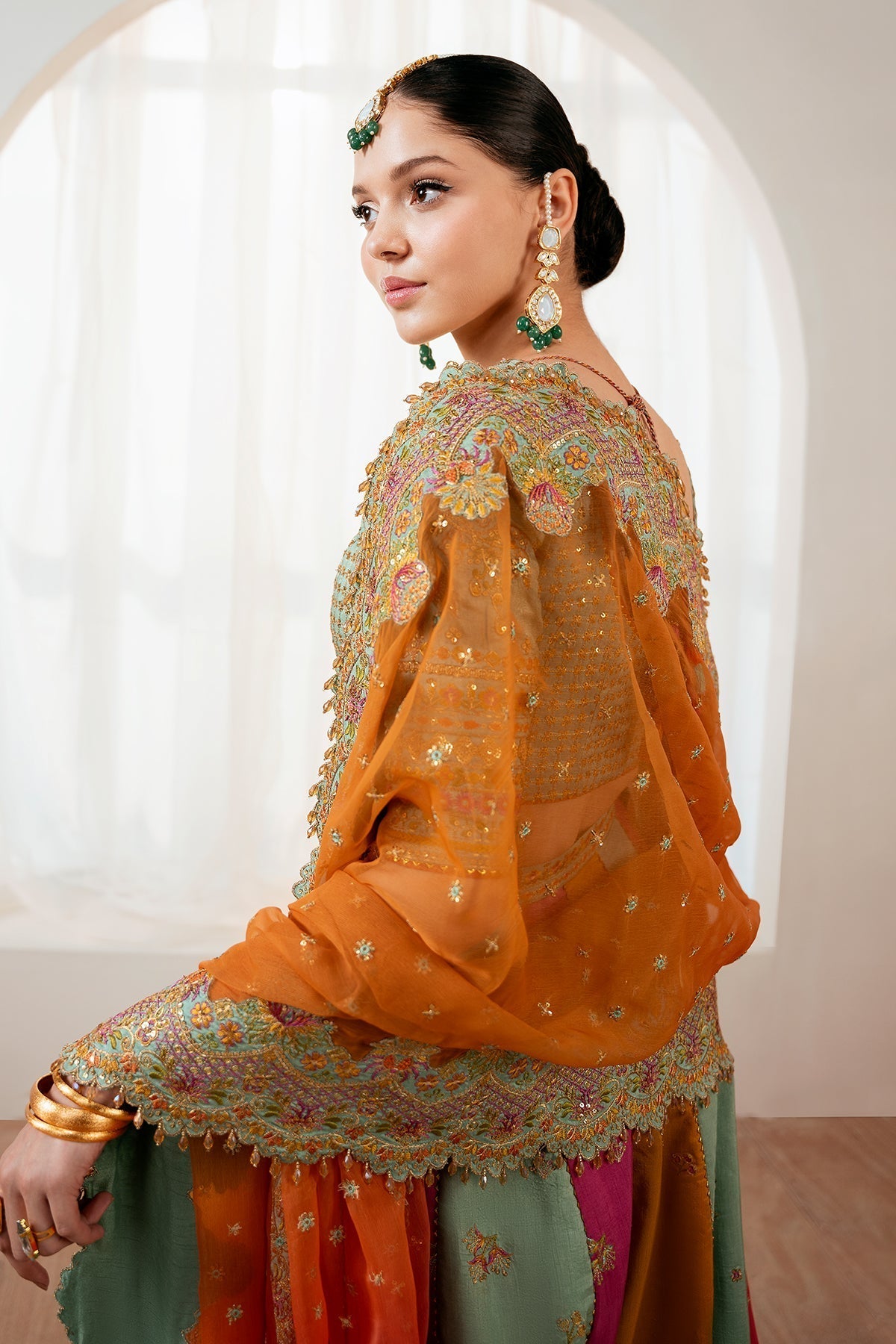Embroidered silk lehenga set showing orange dupatta scalloped border detail