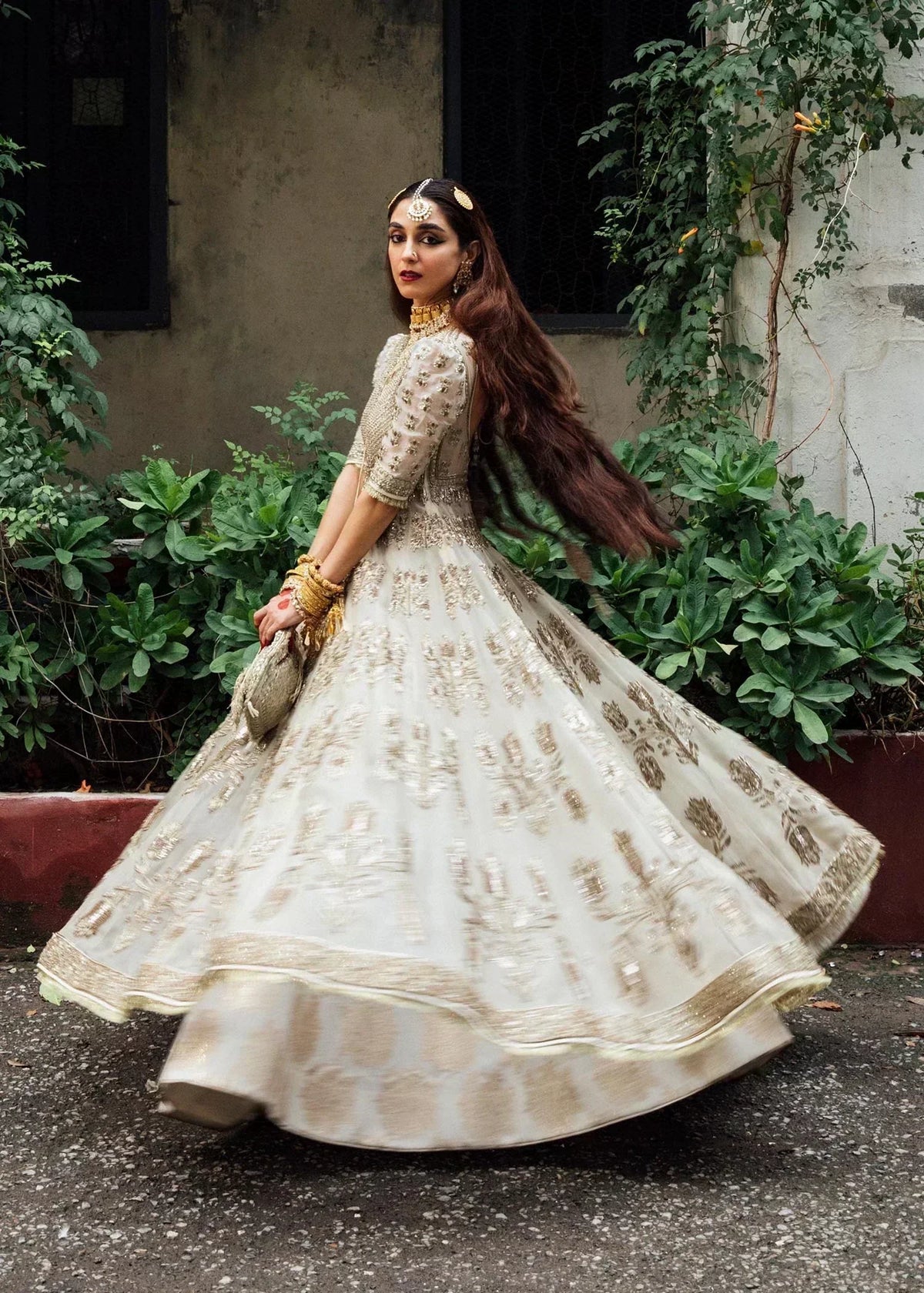 Hussain Rehar Saheda ivory embroidered gown twirling view showing flared skirt