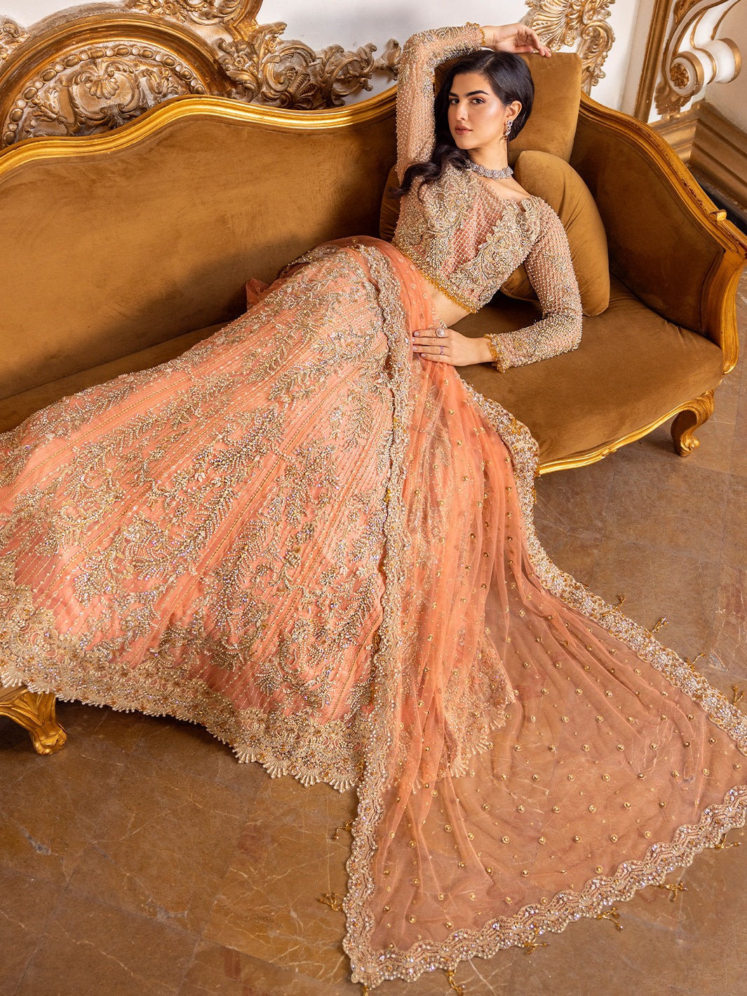 Epoque Soiree Style coral peach bridal lehenga seated full look with dupatta