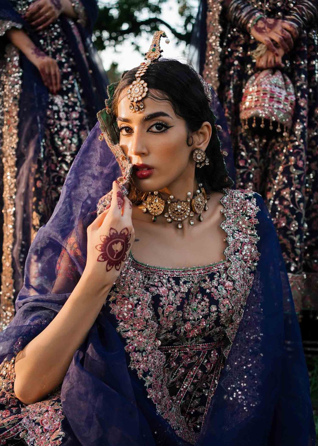 Falak style Pakistani wedding peshwas in navy blue organza with pastel embroidery