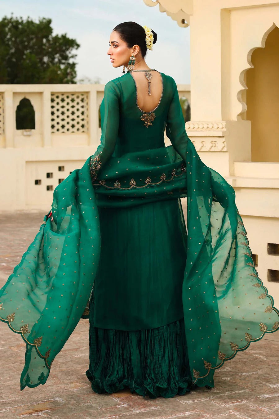 Noor-e-Sabz emerald green outfit back view showing open back and frilled hem