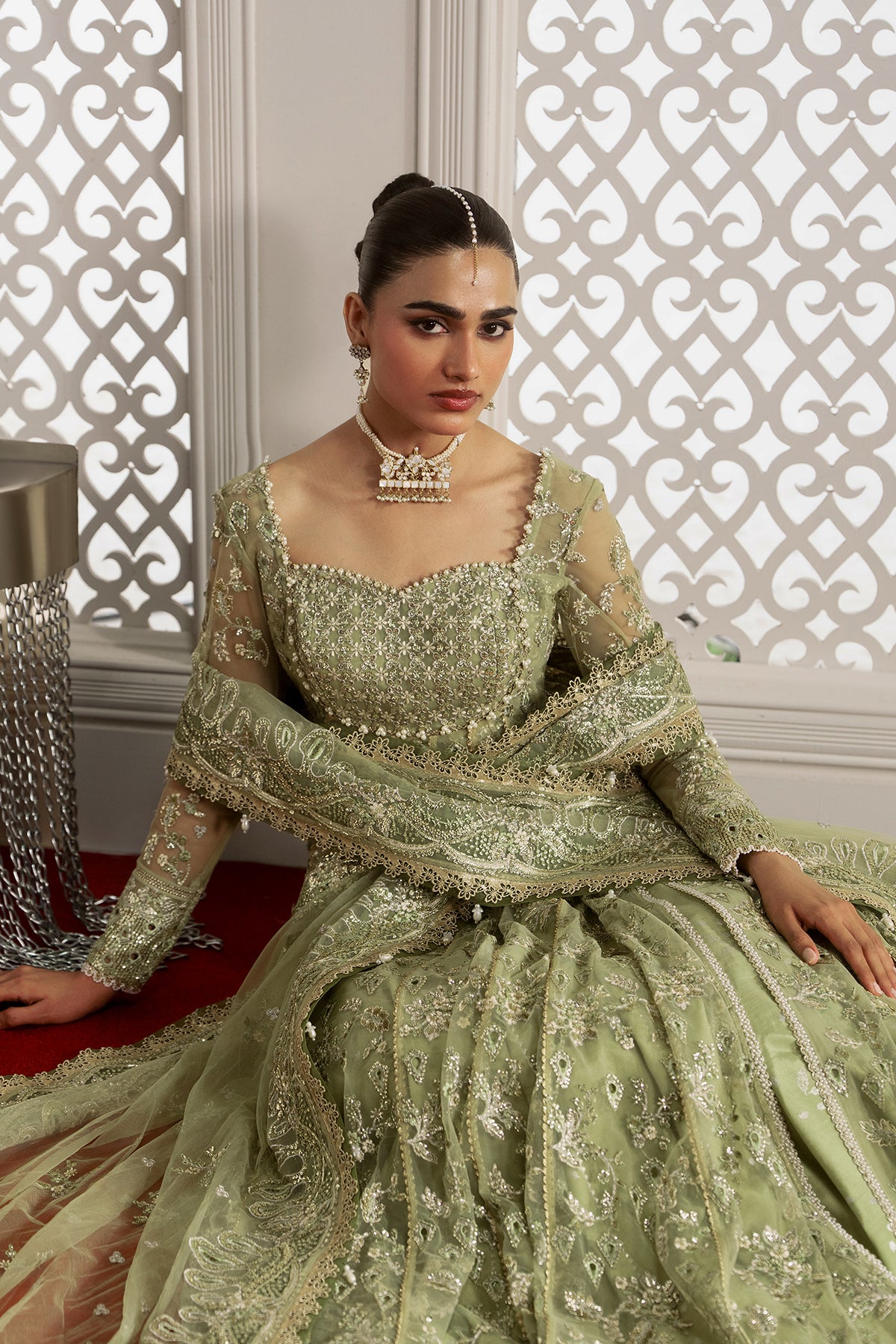 Theodora, made by MAIRAZ — light green pishwas, seated view showing skirt flare
