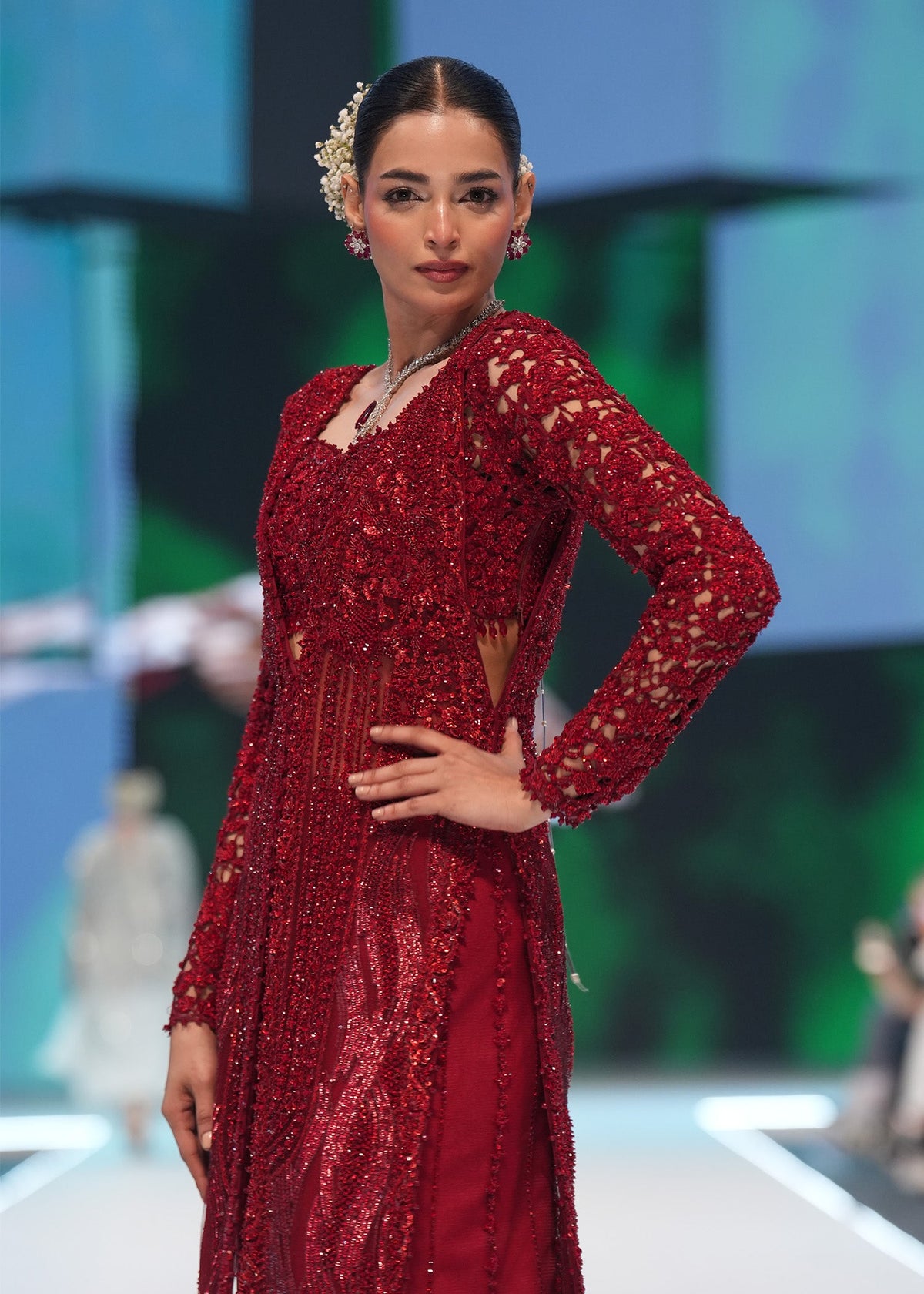 Crimson Desire, made by MAIRAZ — angled view showing cape sleeves and cut-dana, sequin and crystal work