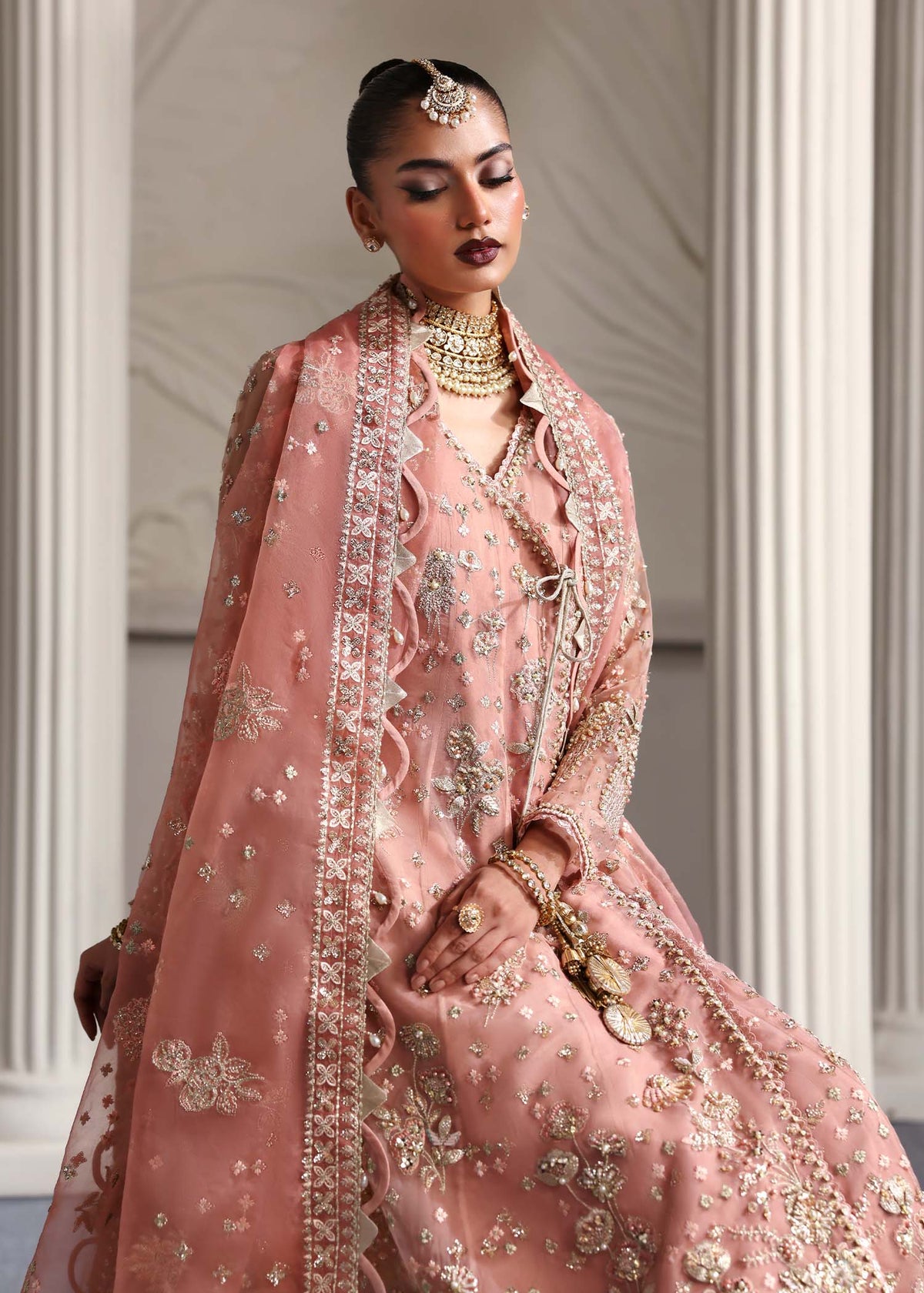 Elza, made by MAIRAZ — peach pink angrakha, seated view showing dupatta