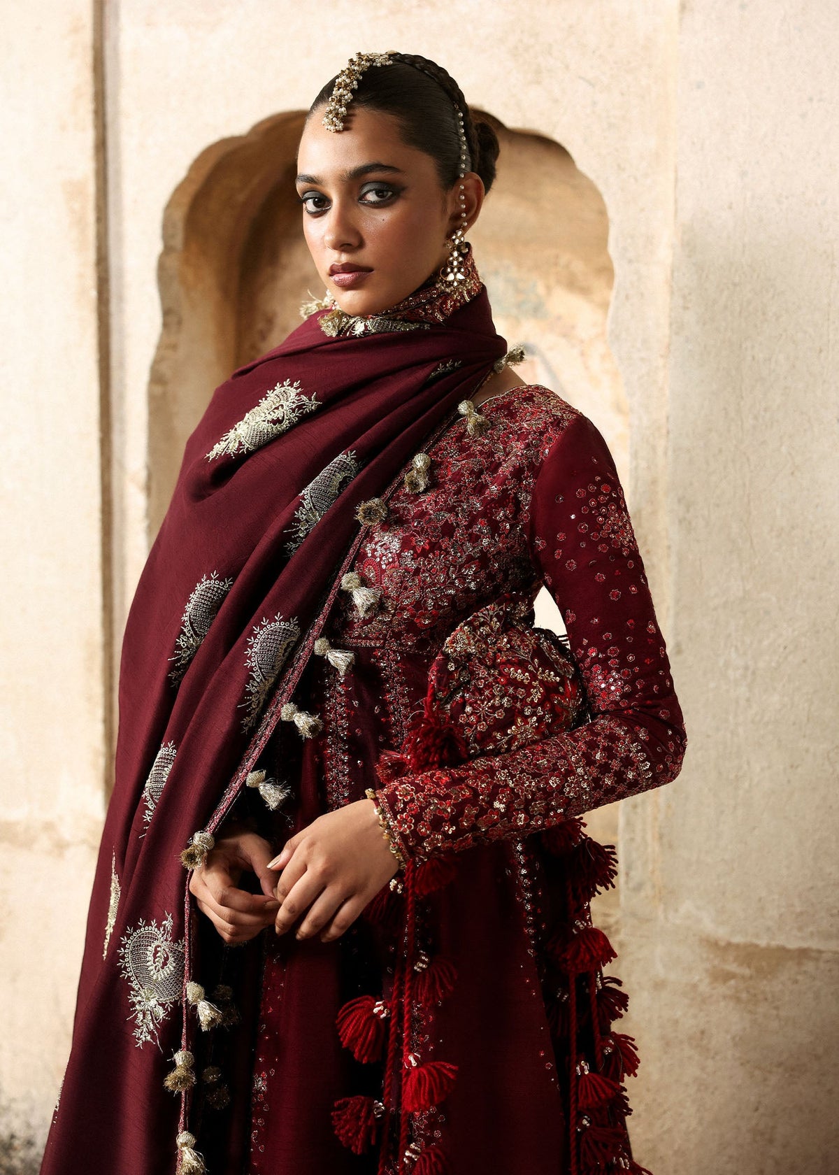 Gulnar, made by MAIRAZ — angled portrait showing sleeve embroidery and shawl motifs