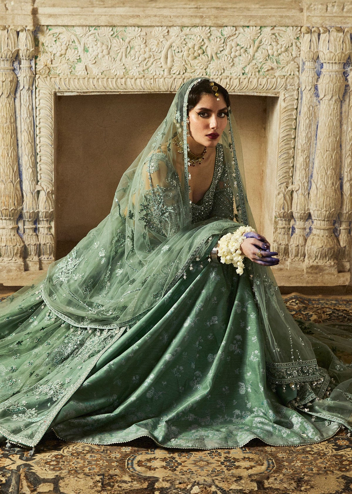 Parag, made by MAIRAZ — seated view showing printed lehenga; design reference
