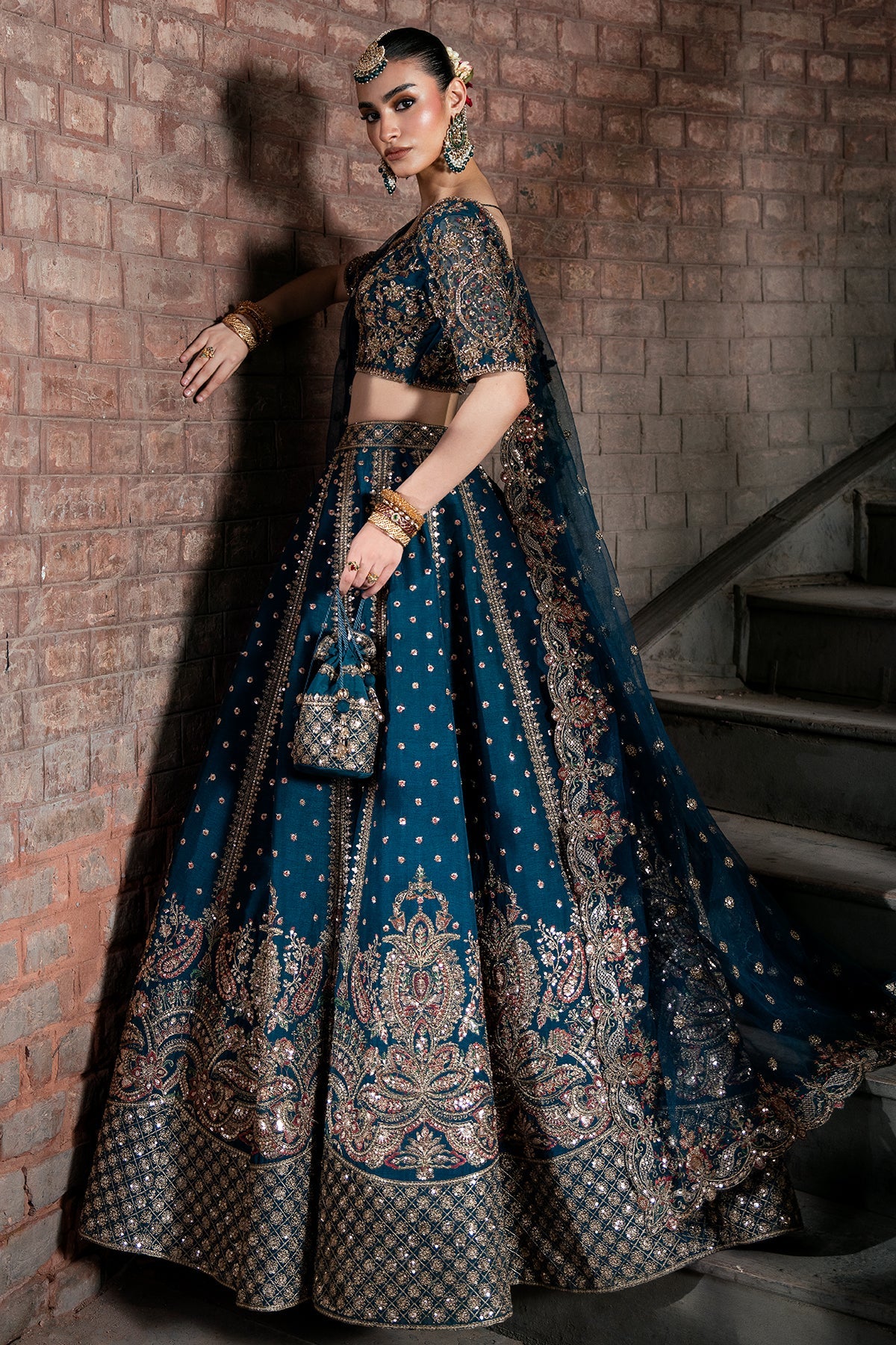 Tabassum, made by MAIRAZ — deep teal lehenga choli, three-quarter side view
