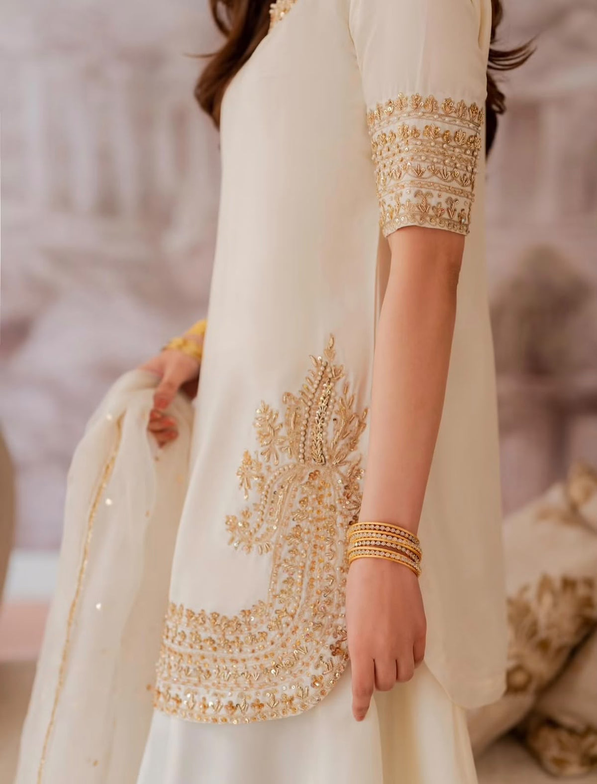Shanzay & Anooshay White Sharara Style by MAIRAZ — close-up of gold floral side motif, hem and cuff